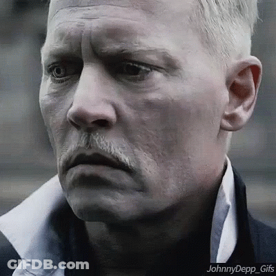 A Close Up Of A Man 'S Face With A Mustache And A White Shirt . GIF