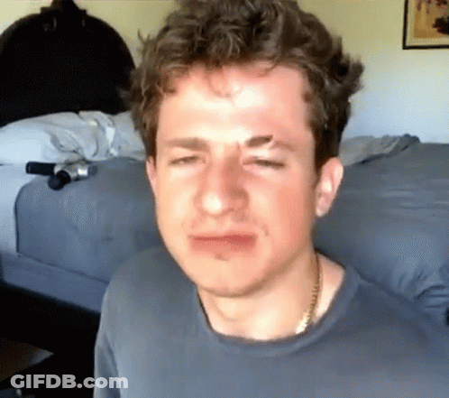 A Close Up Of A Man 'S Face With A Necklace Around His Neck GIF