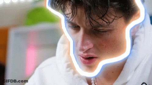 A Close Up Of A Man 'S Face With A Neon Line Around His Mouth GIF