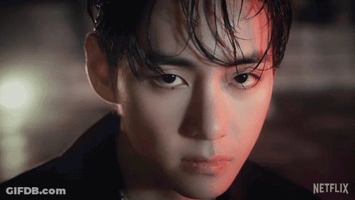 A Close Up Of A Man 'S Face With A Netflix Logo Behind Him GIF