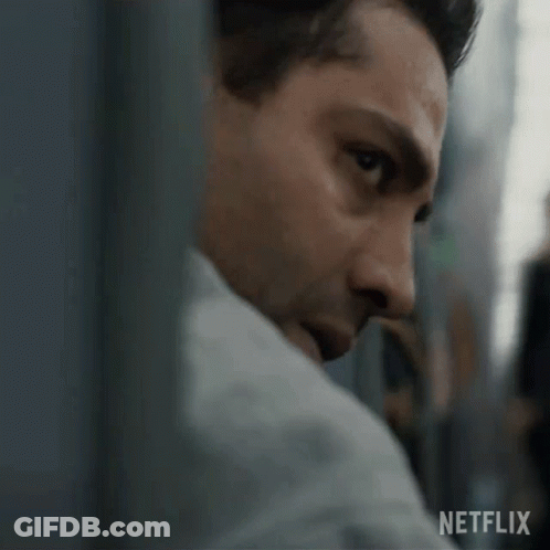 A Close Up Of A Man 'S Face With A Netflix Logo In The Background . GIF