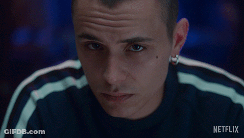 A Close Up Of A Man 'S Face With A Netflix Logo In The Background GIF