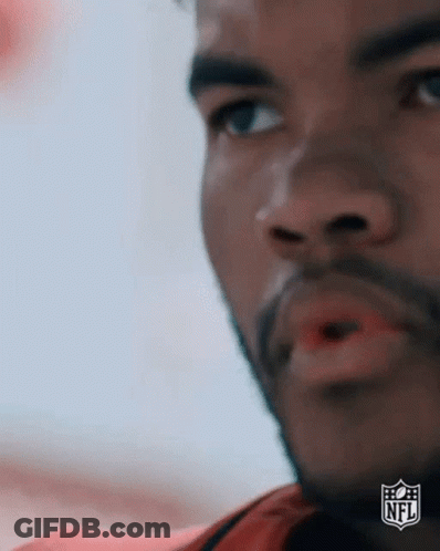 A Close Up Of A Man 'S Face With A NFL Logo On The Bottom Right Corner . GIF