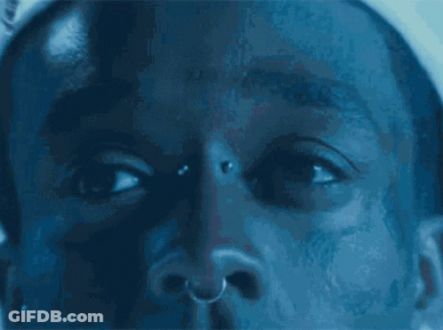 A Close Up Of A Man 'S Face With A Nose Ring GIF