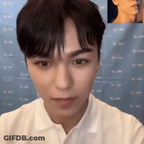 A Close Up Of A Man 'S Face With A Picture Of Another Man 'S Face Behind Him . GIF