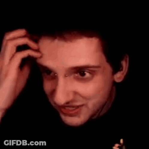 A Close Up Of A Man 'S Face With A Piercing In His Nose Making A Face . GIF