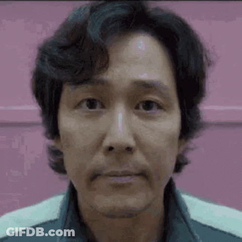 A Close Up Of A Man 'S Face With A Pink Background And A Beard . GIF