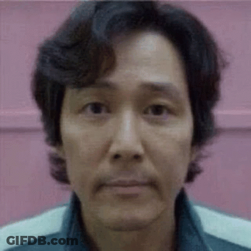 A Close Up Of A Man 'S Face With A Pink Background And A Blurred Background . GIF