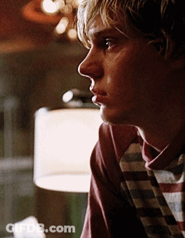 A Close Up Of A Man 'S Face With A Plaid Shirt On GIF