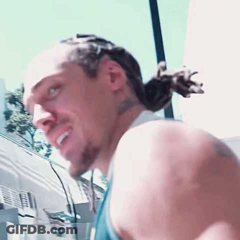 A Close Up Of A Man 'S Face With A Ponytail GIF