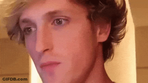 A Close Up Of A Man 'S Face With A Purple Background . GIF