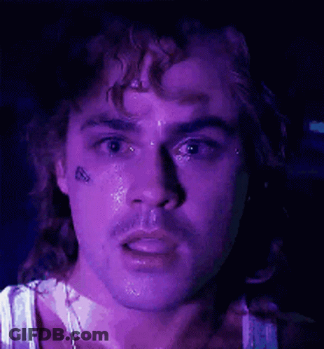 A Close Up Of A Man 'S Face With A Purple Background . GIF