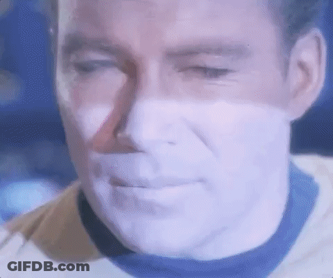 A Close Up Of A Man 'S Face With A Purple Glow On It . GIF