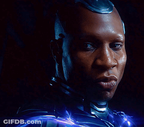 A Close Up Of A Man 'S Face With A Purple Light Behind Him GIF