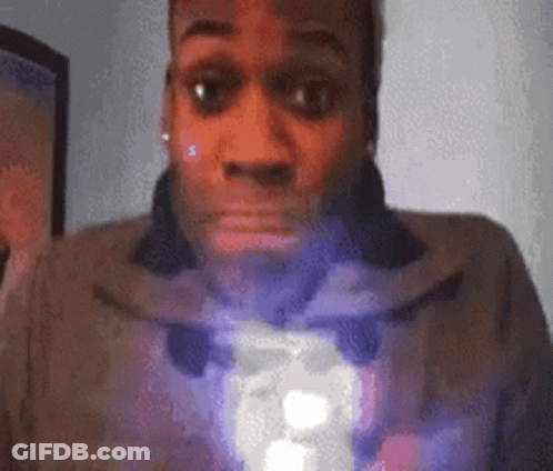 A Close Up Of A Man 'S Face With A Purple Light Coming Out Of His Mouth GIF