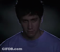 A Close Up Of A Man 'S Face With A Purple Shirt On GIF