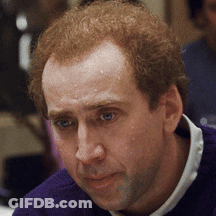 A Close Up Of A Man 'S Face With A Purple Sweater GIF