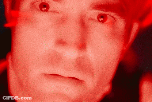 A Close Up Of A Man 'S Face With A Red Background GIF