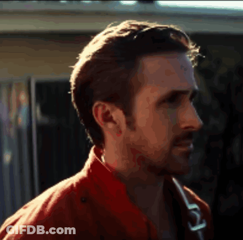 A Close Up Of A Man 'S Face With A Red Jacket On GIF