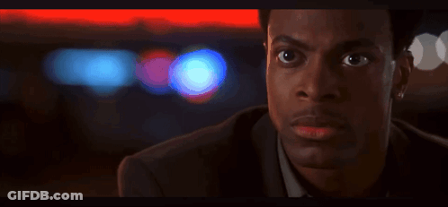 A Close Up Of A Man 'S Face With A Red Light In The Background GIF
