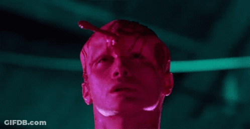 A Close Up Of A Man 'S Face With A Red Liquid Coming Out Of His Head . GIF