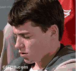 A Close Up Of A Man 'S Face With A Red Shirt In The Background GIF