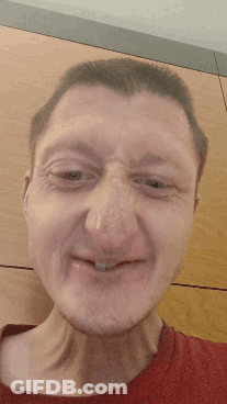 A Close Up Of A Man 'S Face With A Red Shirt On GIF