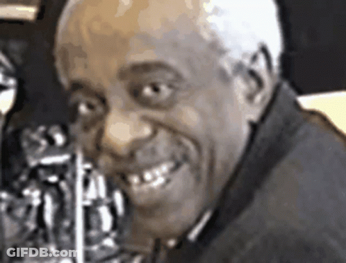 A Close Up Of A Man 'S Face With A Saxophone In His Mouth GIF