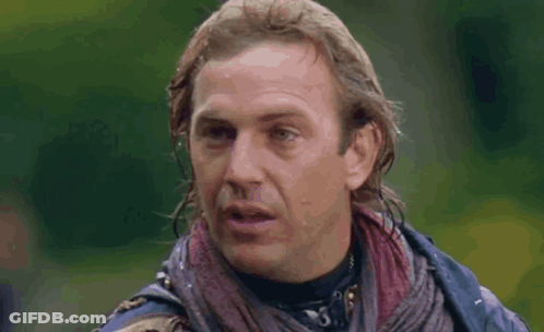 A Close Up Of A Man 'S Face With A Scarf Around His Neck . GIF