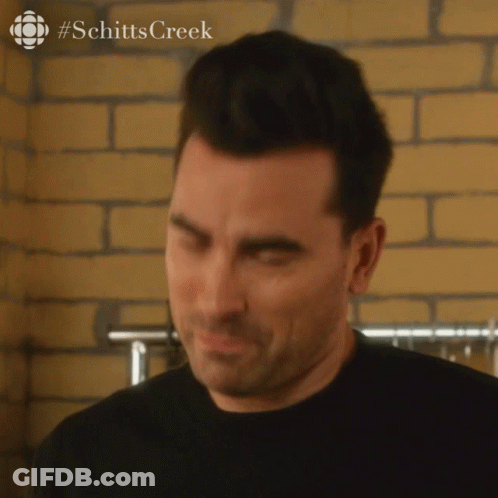 A Close Up Of A Man 'S Face With A #Schitts Creek Logo In The Corner GIF