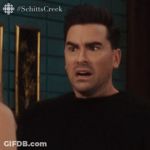 A Close Up Of A Man 'S Face With A #Schitts Creek Logo In The Corner GIF