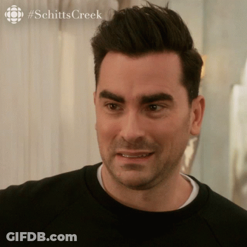 A Close Up Of A Man 'S Face With A #Schitts Creek Logo In The Corner GIF