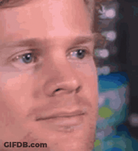 A Close Up Of A Man 'S Face With A Serious Expression On His Face . GIF