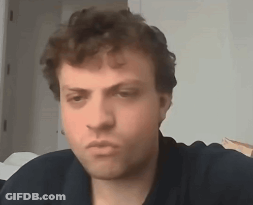 A Close Up Of A Man 'S Face With A Serious Look On His Face . GIF