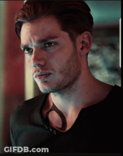 A Close Up Of A Man 'S Face With A Shadow On His Chest GIF