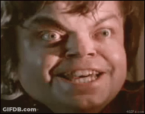 A Close Up Of A Man 'S Face With A Shadow On His Face Making A Funny Face . GIF