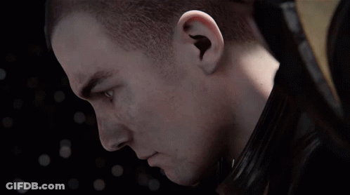 A Close Up Of A Man 'S Face With A Shaved Head And Blue Eyes GIF