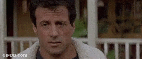 A Close Up Of A Man 'S Face With A Sheep 'S Fur Jacket On . GIF