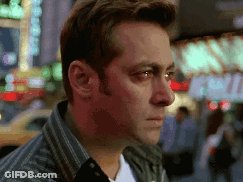 A Close Up Of A Man 'S Face With A Sign In The Background That Says ' Exit ' GIF