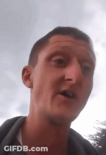 A Close Up Of A Man 'S Face With A Sky Background GIF