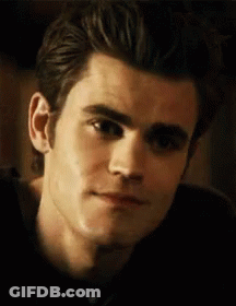 A Close Up Of A Man 'S Face With A Slight Smile . GIF