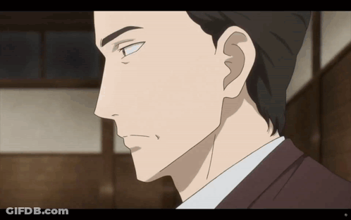 A Close Up Of A Man 'S Face With A Slight Smile On His Face GIF