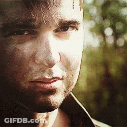 A Close Up Of A Man 'S Face With A Slight Smile On His Face . GIF