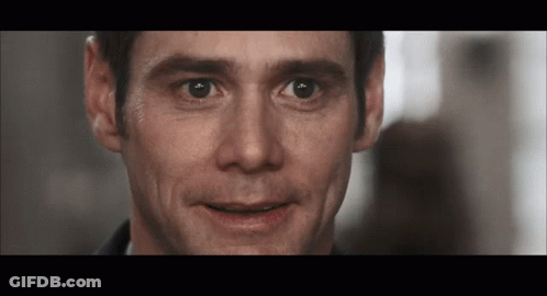 A Close Up Of A Man 'S Face With A Slight Smile On His Face GIF