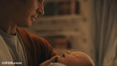 A Close Up Of A Man 'S Face With A Slight Smile On His Face GIF