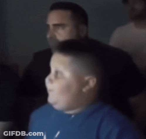A Close Up Of A Man 'S Face With A Slight Smile On His Face GIF