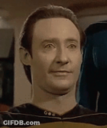 A Close Up Of A Man 'S Face With A Slight Smile On It . GIF