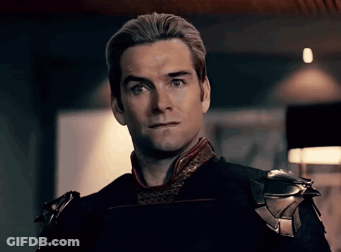A Close Up Of A Man 'S Face With A Slight Smirk On His Face GIF