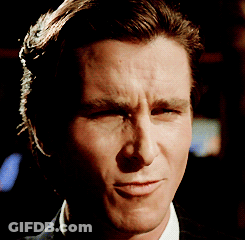 A Close Up Of A Man 'S Face With A Slight Smirk On His Face GIF