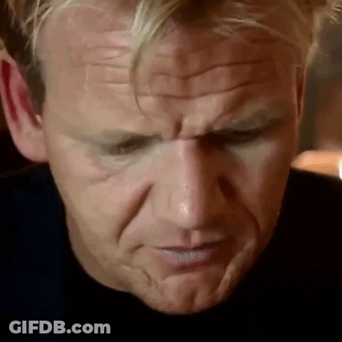 A Close Up Of A Man 'S Face With A Slight Smirk On It . GIF